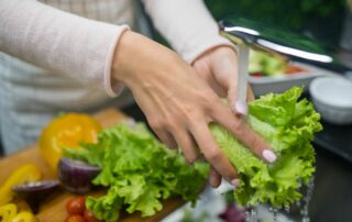 woman washing vegetables