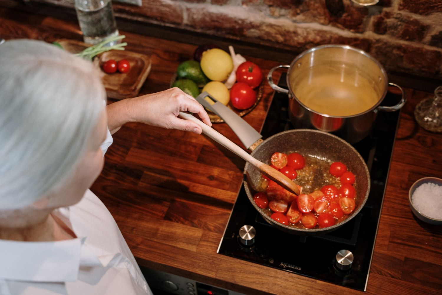 woman cooking on stove 