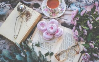 book with dessert, tea and flowers