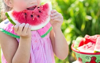 child eating watermelon