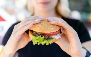 woman holding burger