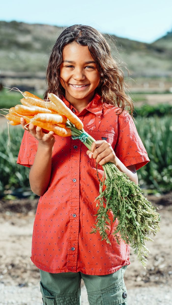 child picking carrots