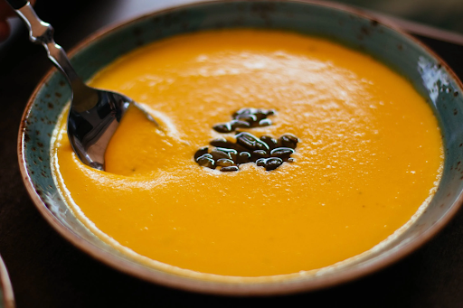 squash soup in bowl with garnish