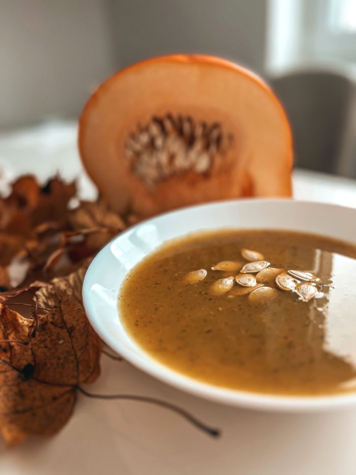 sliced squash alongside soup bowl