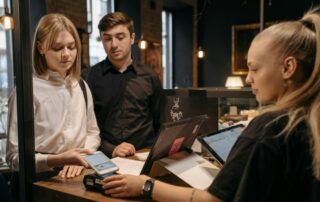 Young Adults at Cafe tipping Server