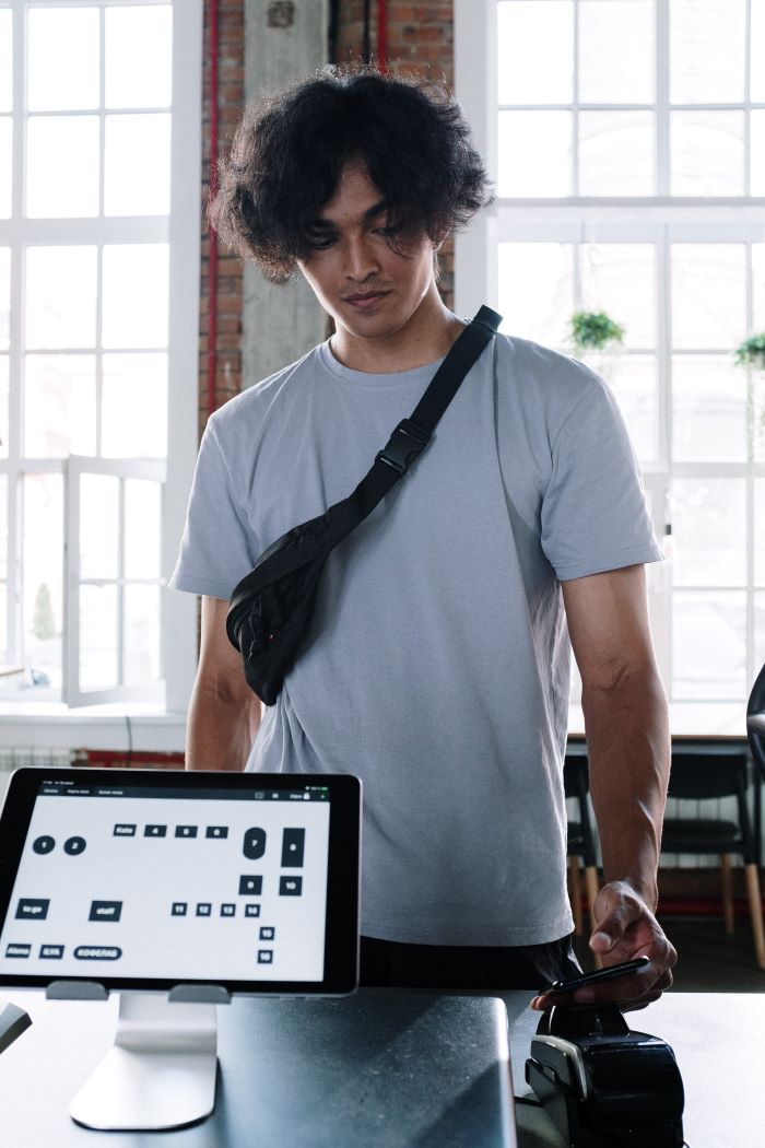 man at counter providing electronic tip