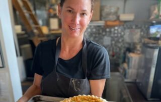 Chef Becky Geisel with tray of food