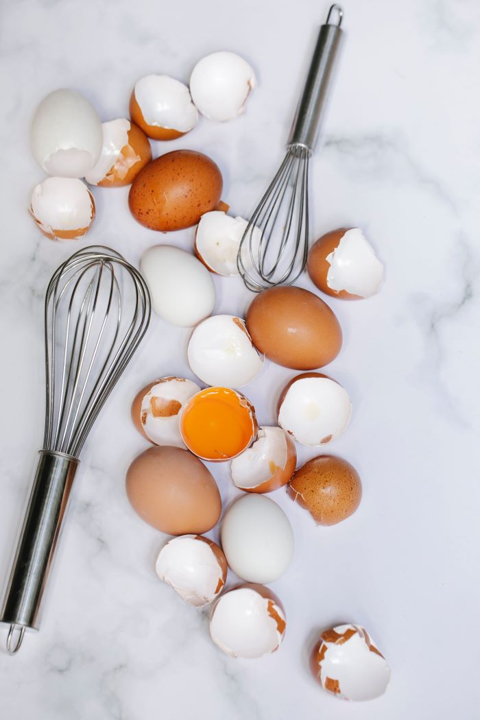 eggs and cracked eggs with whisk